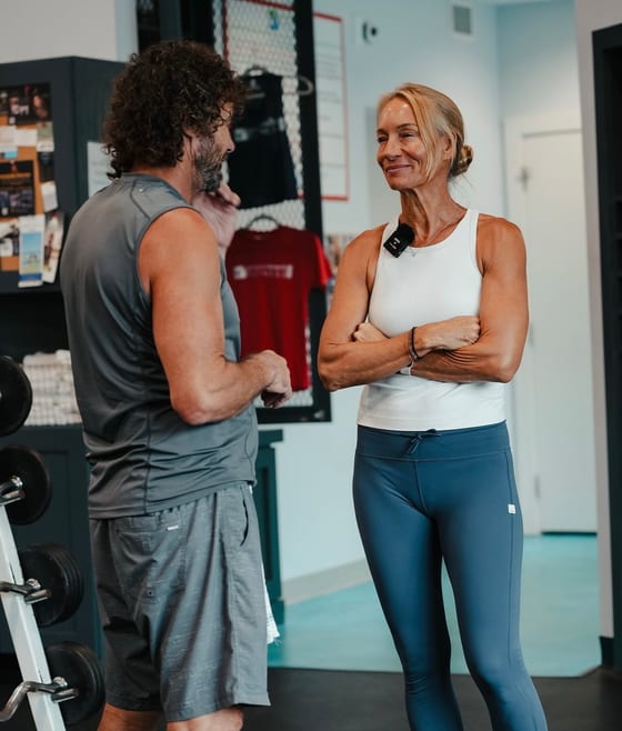 A Grayton Beach Fitness trainer talking with a member on the training floor