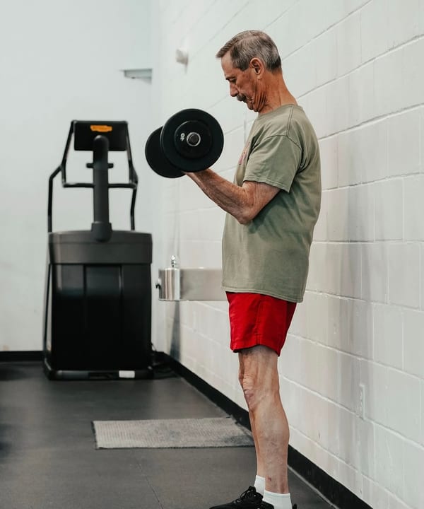 A Grayton Beach Fitness member training with dumbbells on the floor